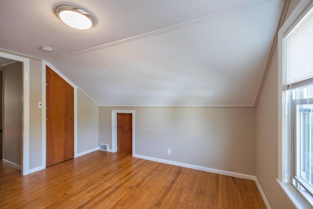 2 Tucker St, Lewiston, ME 04240 - additional living space with vaulted ceiling, hardwood / wood-style flooring, and healthy amount of natural light