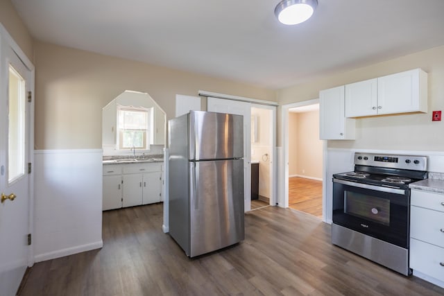 2 Tucker St, Lewiston, ME 04240 - kitchen with stainless steel appliances, dark wood-style floors, and white cabinets