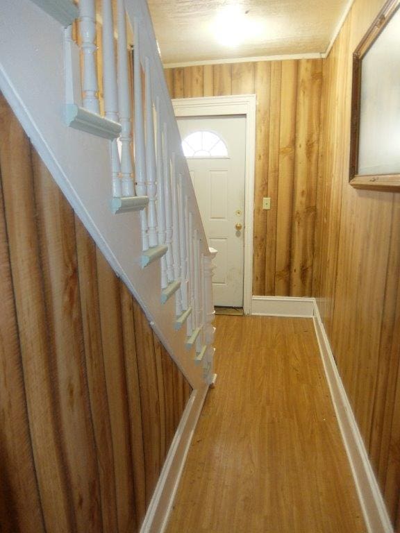 175 Alfred St, Biddeford, ME 04005 - entrance foyer featuring wood walls, wood finished floors, and stairs
