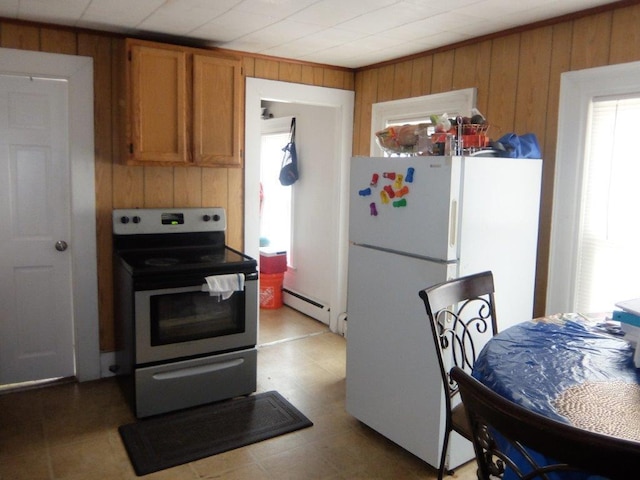 175 Alfred St, Biddeford, ME 04005 - kitchen with stainless steel electric range, wood walls, a baseboard heating unit, freestanding refrigerator, and brown cabinetry