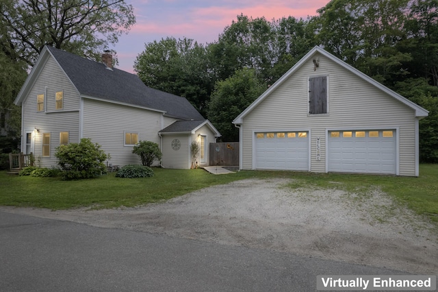 23 Cottage Dr, Friendship, ME 04547 - property exterior at dusk with a chimney, a lawn, a detached garage, roof with shingles, and an outdoor structure