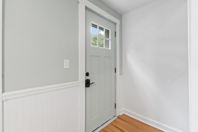 23 Cottage Dr, Friendship, ME 04547 - doorway to outside featuring a wainscoted wall and light wood-style flooring