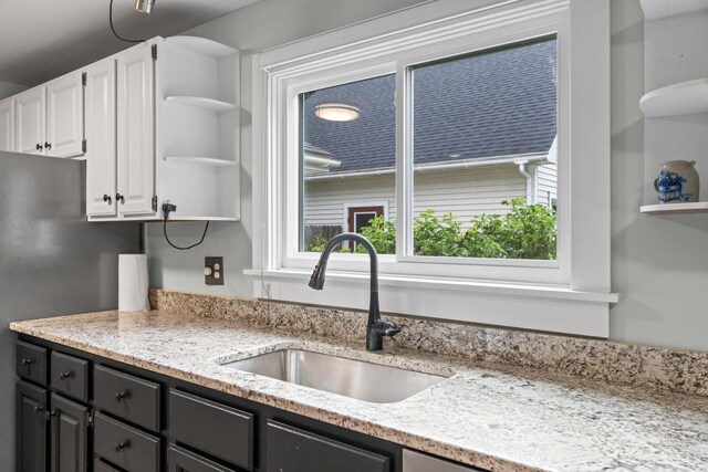23 Cottage Dr, Friendship, ME 04547 - kitchen featuring open shelves, white cabinets, dark cabinetry, light stone countertops, and freestanding refrigerator