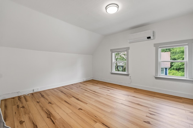 23 Cottage Dr, Friendship, ME 04547 - additional living space with a wall mounted AC, light wood-style floors, and vaulted ceiling
