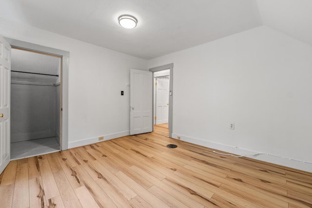23 Cottage Dr, Friendship, ME 04547 - unfurnished bedroom featuring hardwood / wood-style floors, a closet, and a walk in closet