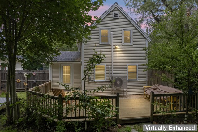 23 Cottage Dr, Friendship, ME 04547 - back of property at dusk with a wooden deck and a shingled roof