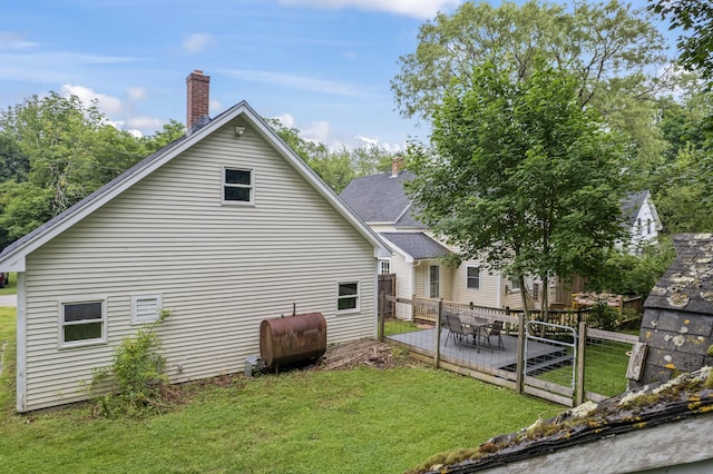 23 Cottage Dr, Friendship, ME 04547 - rear view of property with oil tank, a wooden deck, and a chimney