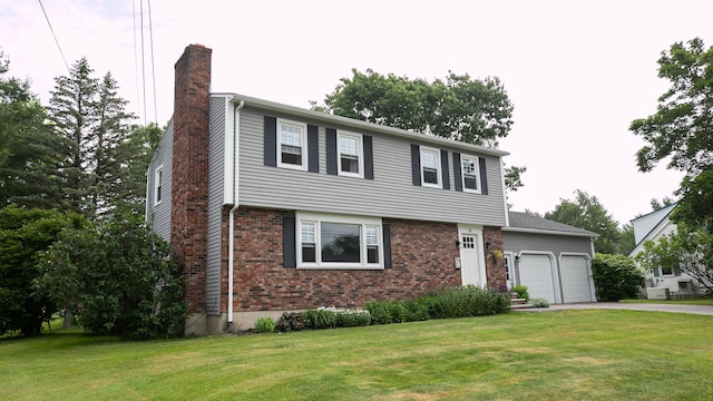 48 Clover Ln, Brewer, ME 04412 - colonial-style house with a chimney, an attached garage, asphalt driveway, a front lawn, and brick siding