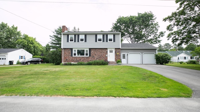 48 Clover Ln, Brewer, ME 04412 - colonial home featuring an attached garage, a chimney, a front lawn, and driveway