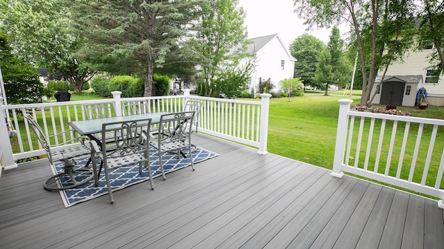 48 Clover Ln, Brewer, ME 04412 - wooden terrace featuring outdoor dining space, a storage shed, and a lawn