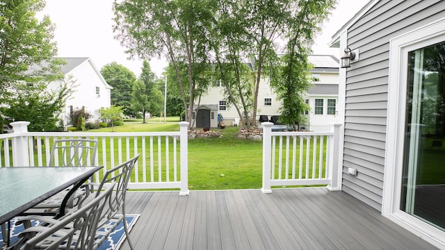 48 Clover Ln, Brewer, ME 04412 - wooden deck featuring a storage unit, a yard, and outdoor dining area