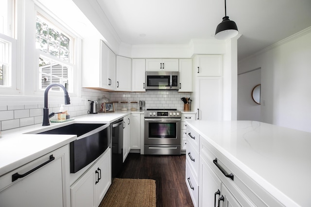 48 Clover Ln, Brewer, ME 04412 - kitchen featuring stainless steel appliances, dark wood-style flooring, decorative backsplash, white cabinets, and crown molding