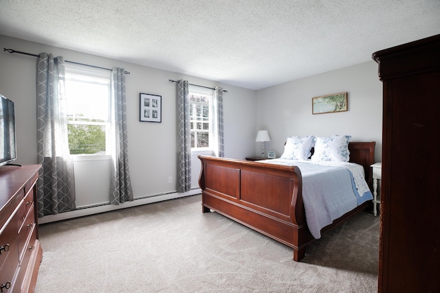 48 Clover Ln, Brewer, ME 04412 - bedroom featuring light colored carpet, multiple windows, a baseboard radiator, and a textured ceiling