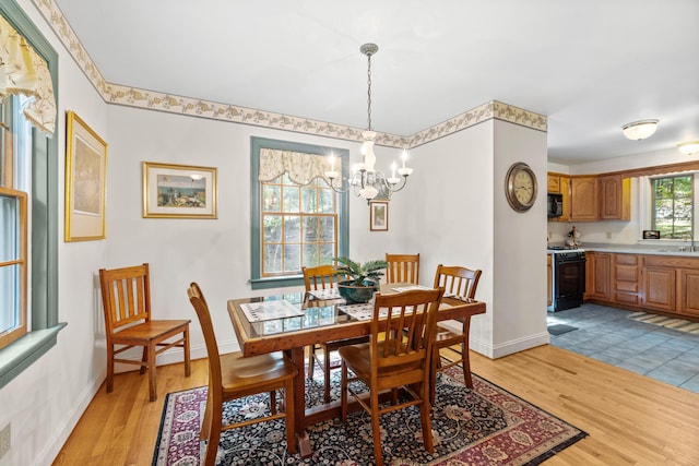 17 Summit St, Ogunquit, ME 03907 - dining area with a chandelier and light wood-type flooring
