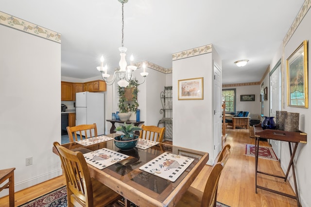 17 Summit St, Ogunquit, ME 03907 - dining area with a chandelier and light wood-type flooring