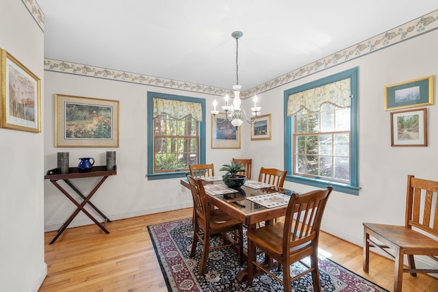 17 Summit St, Ogunquit, ME 03907 - dining room with light wood-type flooring and a chandelier