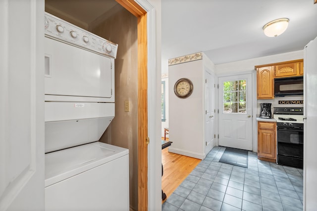 17 Summit St, Ogunquit, ME 03907 - laundry room with stacked washing machine and dryer and light tile patterned floors
