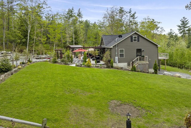 85 Lions Ridge Rd, Alna, ME 04535 - back of property with a yard, a view of trees, and a deck