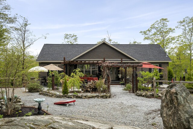 85 Lions Ridge Rd, Alna, ME 04535 - rear view of property featuring roof with shingles, a patio, and a pergola