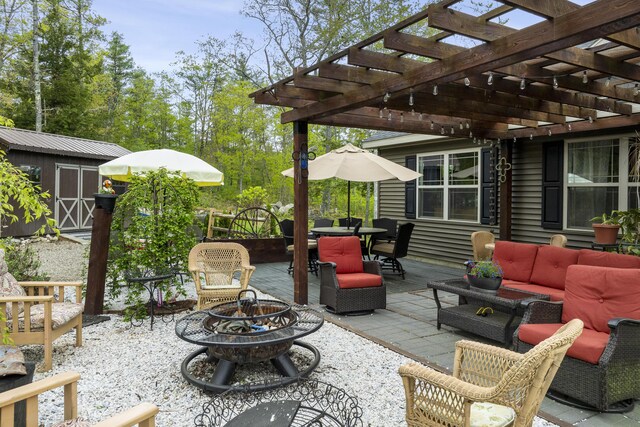 85 Lions Ridge Rd, Alna, ME 04535 - view of patio / terrace with an outdoor living space with a fire pit, a storage shed, outdoor dining area, and a pergola