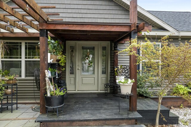 85 Lions Ridge Rd, Alna, ME 04535 - view of exterior entry with a pergola and a shingled roof