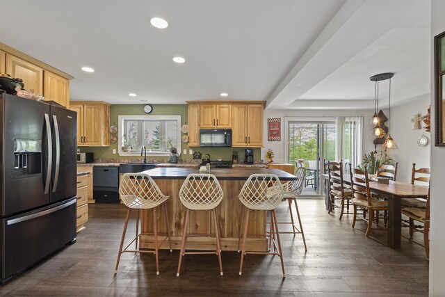85 Lions Ridge Rd, Alna, ME 04535 - kitchen featuring black appliances, light brown cabinetry, recessed lighting, dark wood-style floors, and a breakfast bar