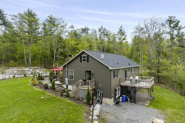 85 Lions Ridge Rd, Alna, ME 04535 - back of property featuring a yard, a wooden deck, a wooded view, and roof with shingles