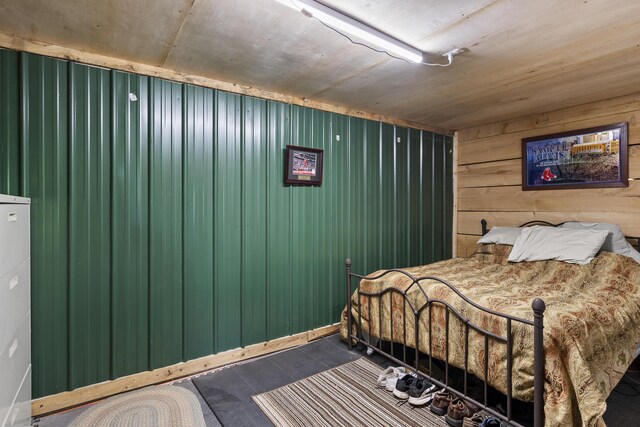 85 Lions Ridge Rd, Alna, ME 04535 - bedroom with wooden walls and dark tile patterned floors
