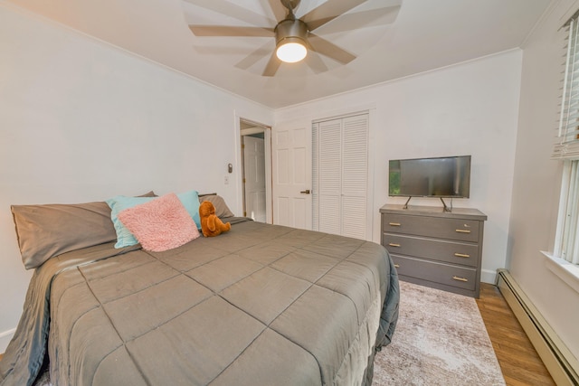 48 Griffin Ave, Hampden, ME 04444 - bedroom featuring baseboard heating, wood finished floors, ornamental molding, a closet, and a ceiling fan