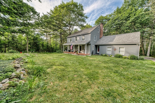48 Griffin Ave, Hampden, ME 04444 - view of front of home featuring a front yard, roof with shingles, a chimney, and a porch