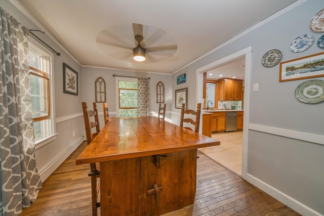 48 Griffin Ave, Hampden, ME 04444 - dining space featuring baseboard heating, ceiling fan, ornamental molding, and light wood finished floors