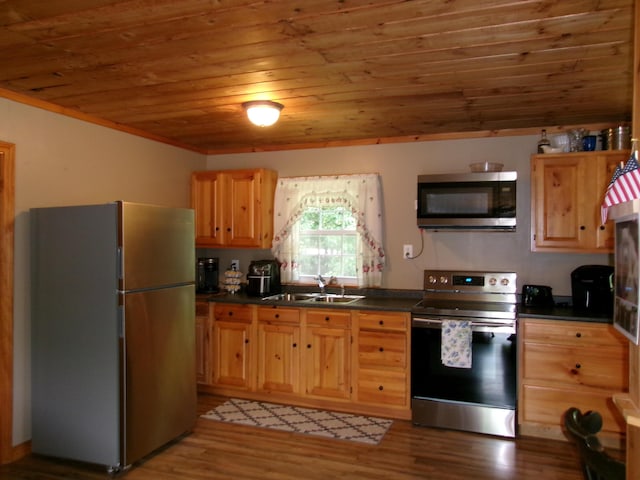 76 Gile Rd, Fayette, ME 04349 - kitchen with stainless steel appliances, wood ceiling, dark countertops, wood finished floors, and light brown cabinets