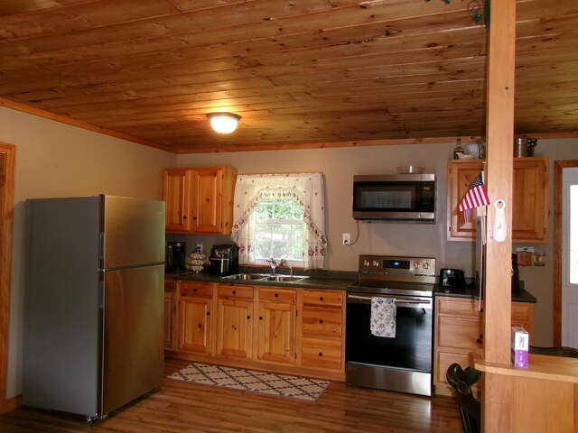 76 Gile Rd, Fayette, ME 04349 - kitchen featuring stainless steel appliances, wood ceiling, dark countertops, light wood-style flooring, and light brown cabinetry