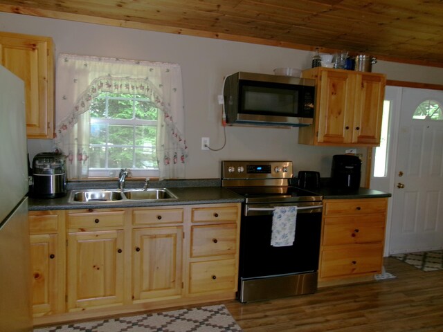 76 Gile Rd, Fayette, ME 04349 - kitchen with appliances with stainless steel finishes, wood finished floors, wooden ceiling, dark countertops, and light brown cabinets