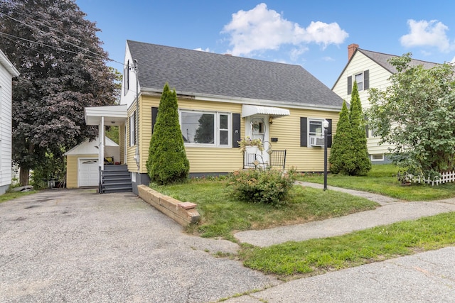 95 Webber Ave, Lewiston, ME 04240 - view of front of home with a shingled roof, cooling unit, an outdoor structure, and driveway