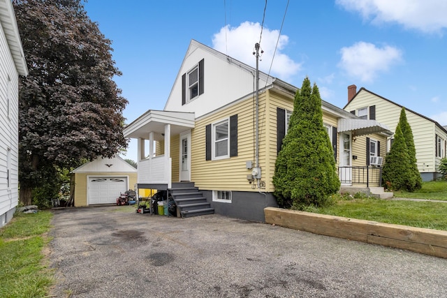 95 Webber Ave, Lewiston, ME 04240 - bungalow-style home featuring an outdoor structure, a detached garage, asphalt driveway, and entry steps