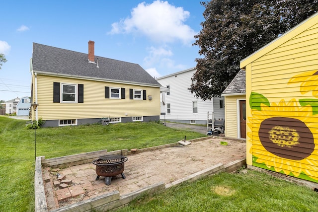 95 Webber Ave, Lewiston, ME 04240 - back of house featuring a fire pit, a lawn, a chimney, a patio, and a shingled roof