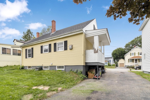 95 Webber Ave, Lewiston, ME 04240 - view of side of home with a chimney and a lawn