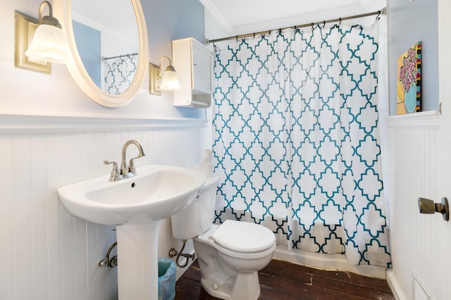 95 Webber Ave, Lewiston, ME 04240 - full bathroom with wainscoting, hardwood / wood-style floors, curtained shower, and a decorative wall