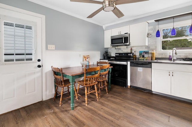 95 Webber Ave, Lewiston, ME 04240 - kitchen with stainless steel appliances, ornamental molding, dark wood-style flooring, white cabinetry, and a ceiling fan