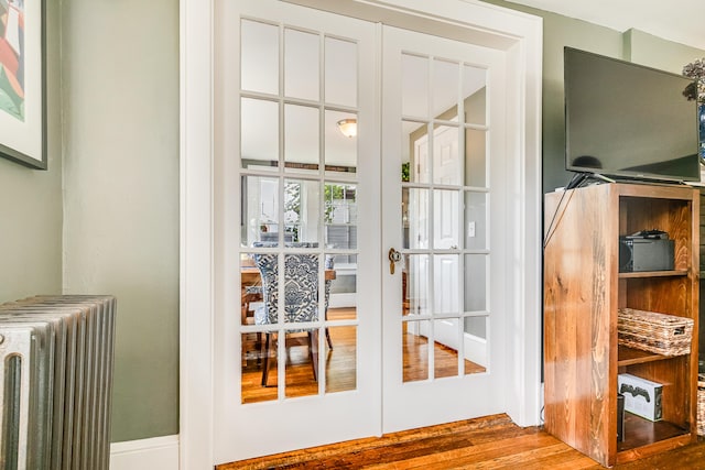 46 Haven Rd, South Portland, ME 04106 - doorway to outside featuring radiator, wood finished floors, and french doors