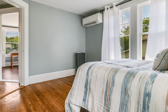 46 Haven Rd, South Portland, ME 04106 - bedroom with a wall unit AC, wood finished floors, and radiator