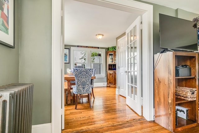 46 Haven Rd, South Portland, ME 04106 - hallway with radiator, wood finished floors, and french doors