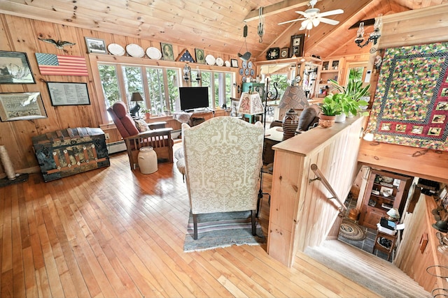 16 Brackett Rd, Dresden, ME 04342 - living area featuring wooden ceiling, wood-type flooring, wood walls, ceiling fan, and a baseboard heating unit