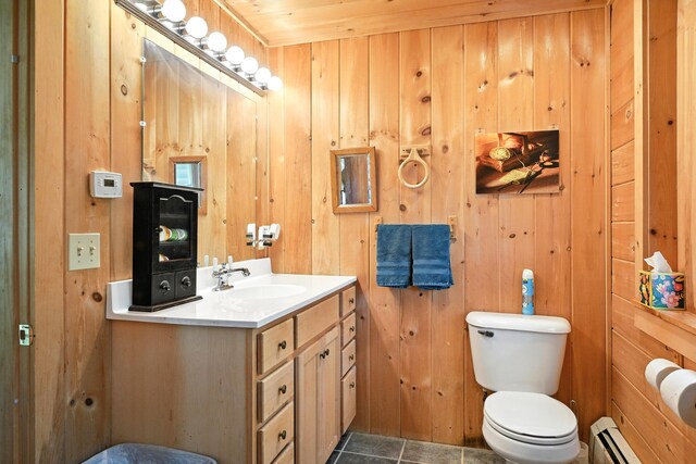 16 Brackett Rd, Dresden, ME 04342 - bathroom featuring a baseboard heating unit, vanity, wood walls, and tile patterned flooring