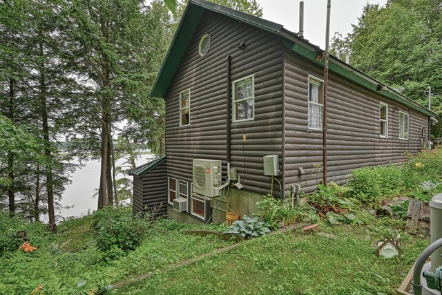 16 Brackett Rd, Dresden, ME 04342 - view of home's exterior featuring log veneer siding and a cooling unit
