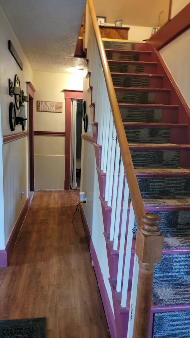 12 High St, Calais, ME 04619 - staircase with wood finished floors and baseboards