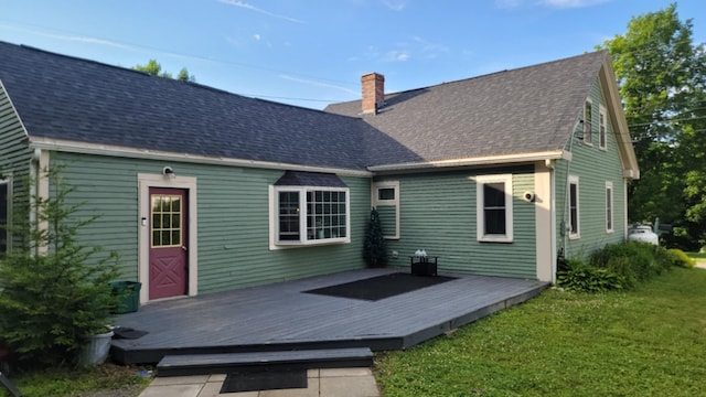 12 High St, Calais, ME 04619 - rear view of house with a chimney, a yard, a deck, and roof with shingles