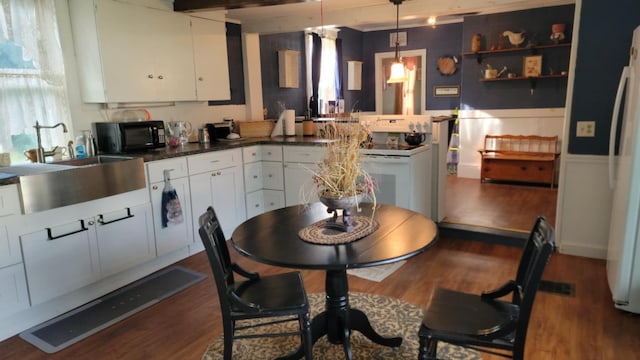 12 High St, Calais, ME 04619 - kitchen with white appliances, white cabinets, and dark wood finished floors