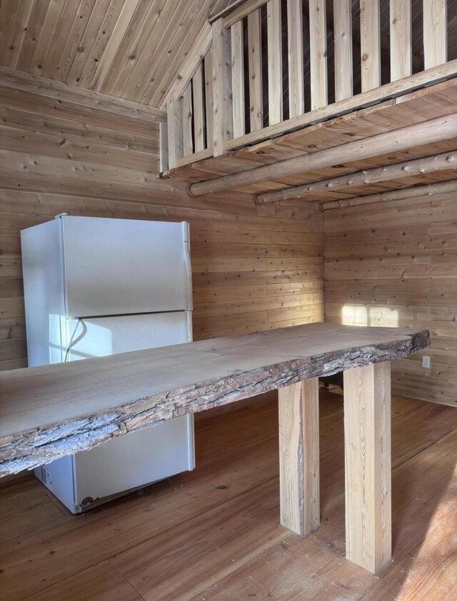 MAP7LOT54 Paine Rd, Dover-Foxcroft, ME 04426 - detailed view of freestanding refrigerator, wood walls, wood ceiling, and wood finished floors